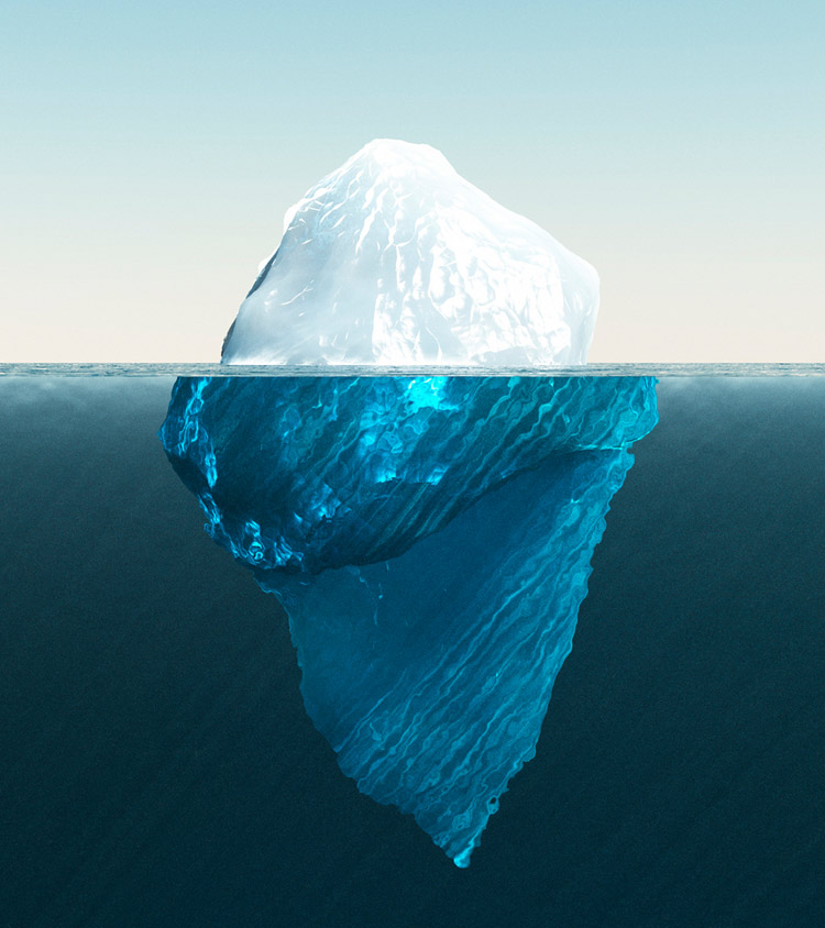 Photo of an iceberg showing above and below water level
